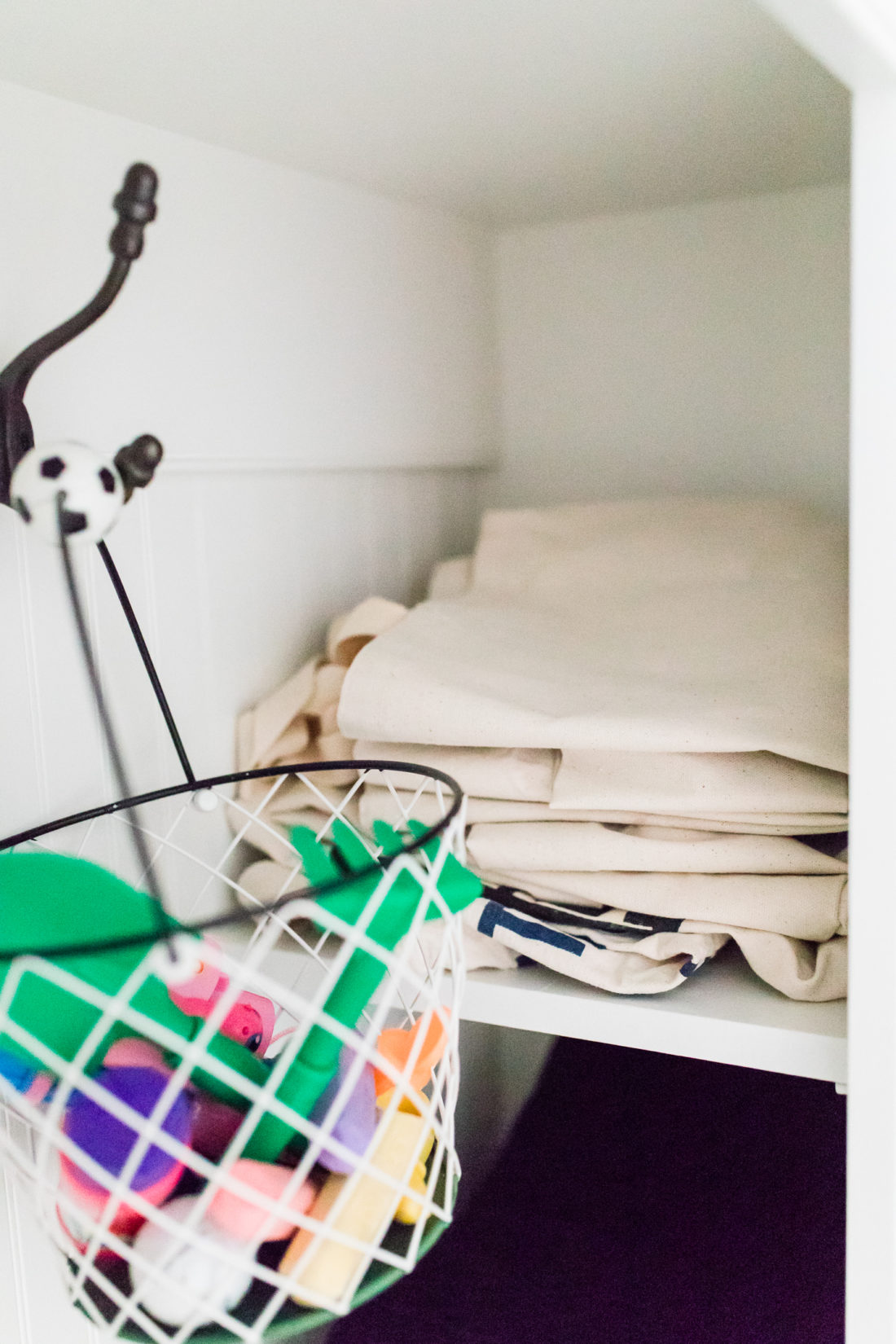 stacked canvas bags in the cubby of Eva Amurri Martino's Connecticut mud room