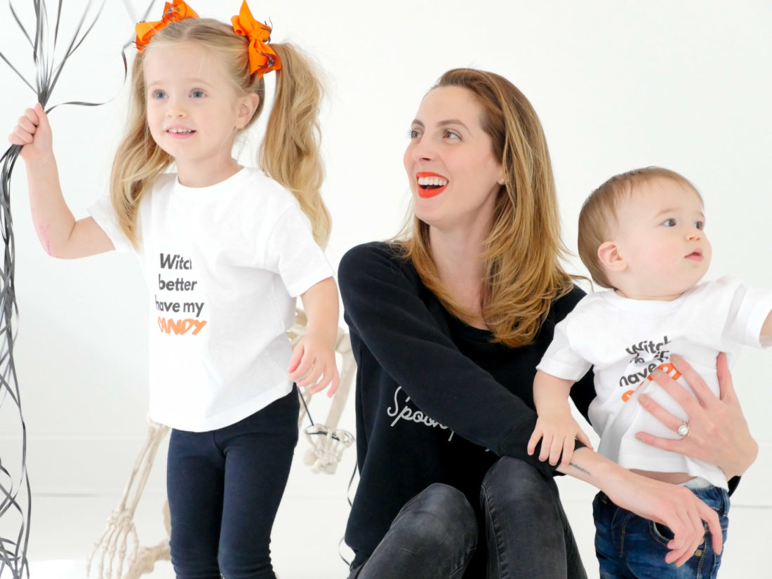Eva Amurri Martino sits with children Marlowe and Major wearing custom Halloween themed tee shirts designed using The Happily App