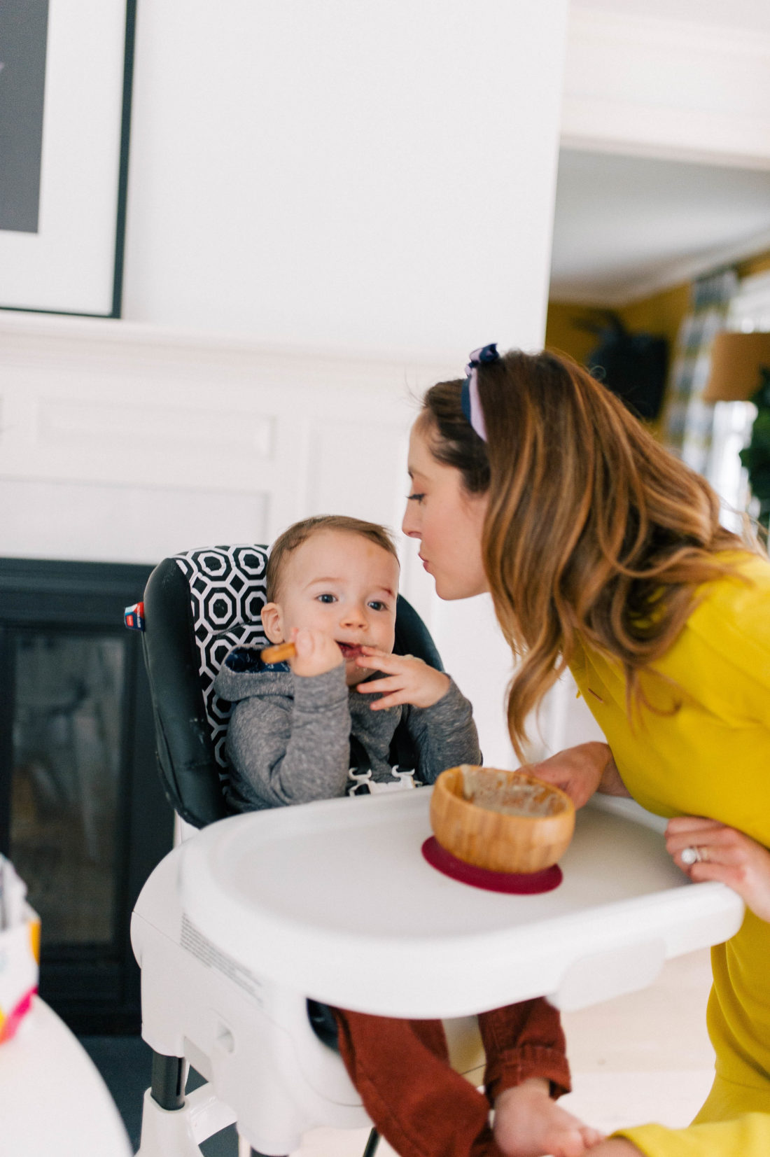 Eva Amurri Martino leans in to kiss son Major in his high chair in the kitchen of her Connecticut home
