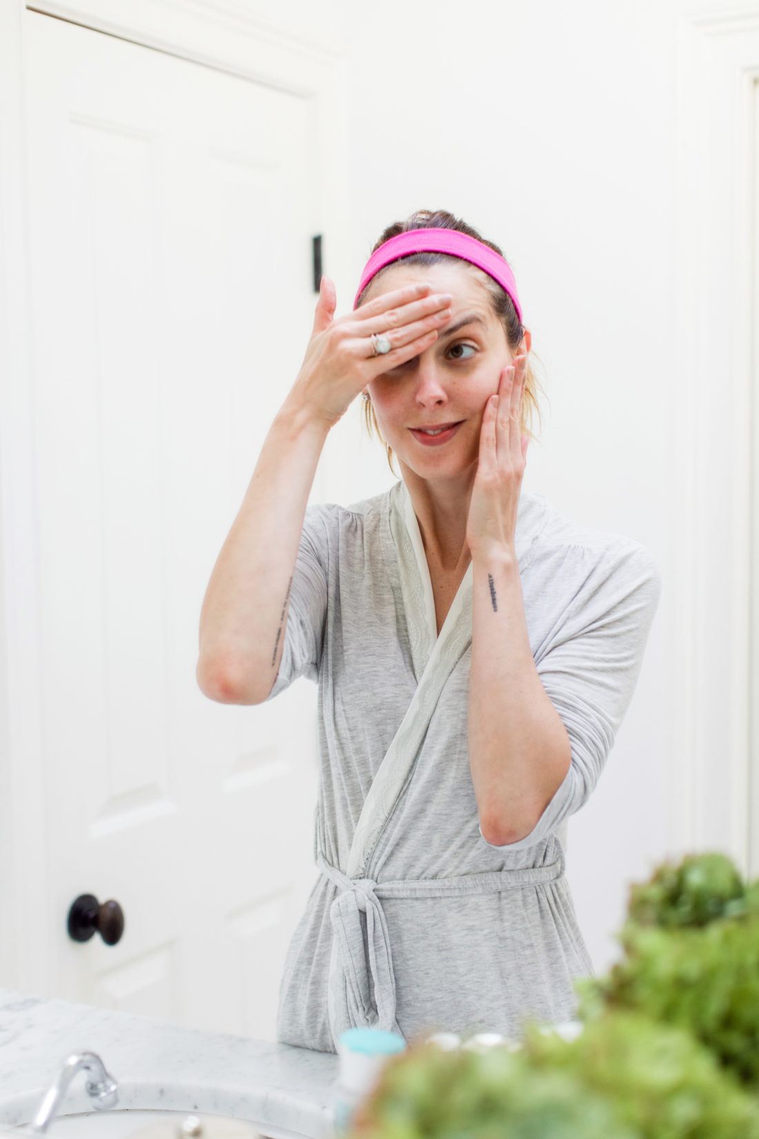 Eva Amurri Martino presses retinol cream in to her skin in the bathroom of her Connecticut home