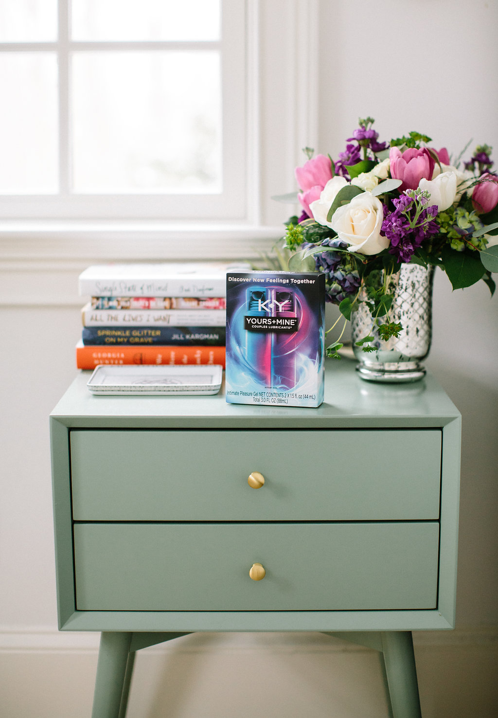 A box of K-Y lubricant sits on the bedside table along with a bouquet of flowers and a stack of books in the Master Bedroom of Eva Amurri Martino's Connecticut home