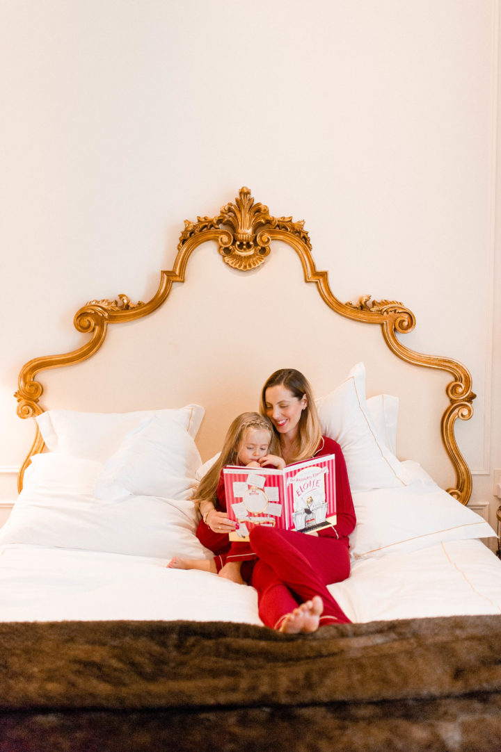 Eva Amurri Martino reads Eloise to her daughter Marlowe on a bed at the Plaza Hotel in New York City