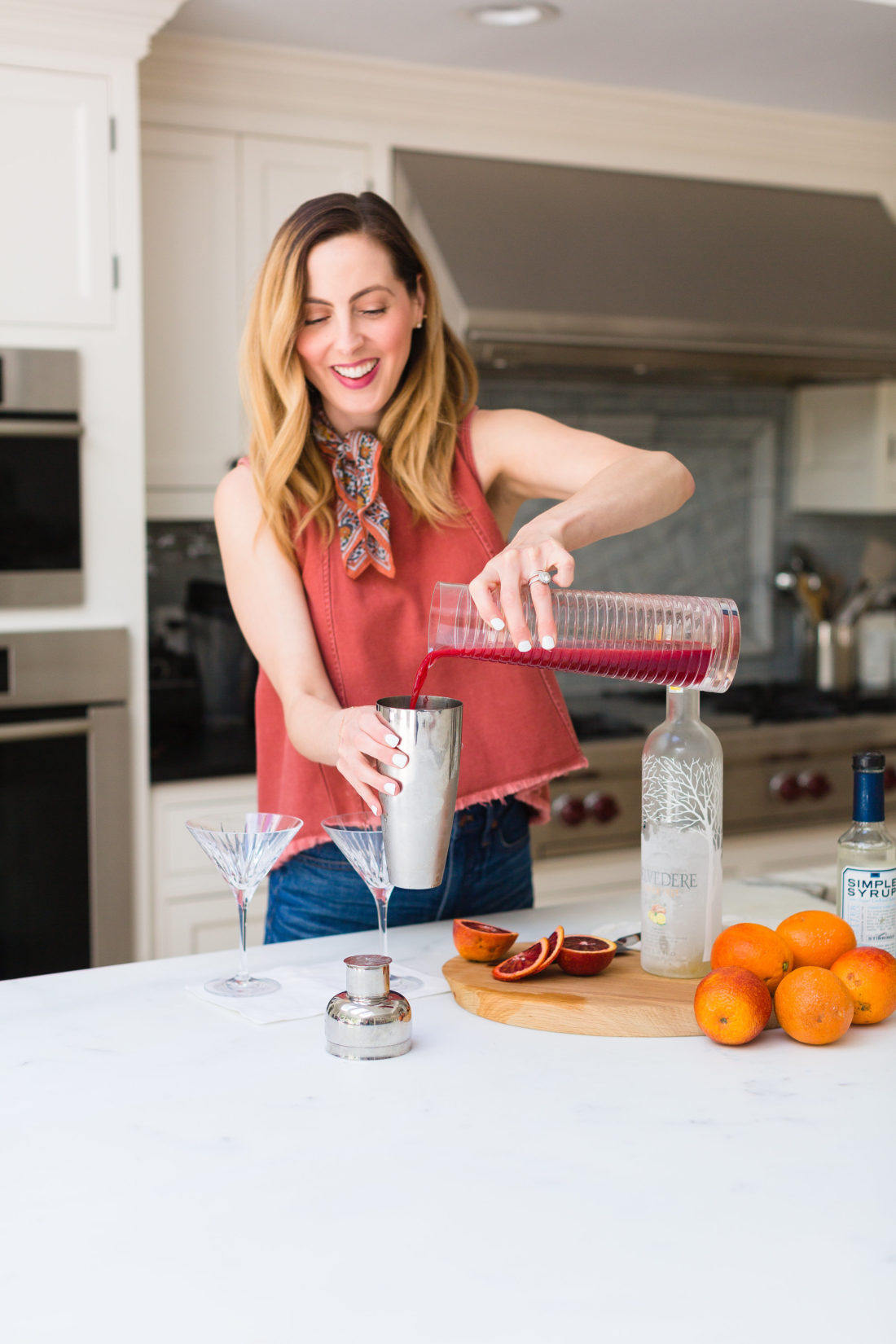 Eva Amurri Martino adds freshly squeezed blood orange juice to a cocktail shaker