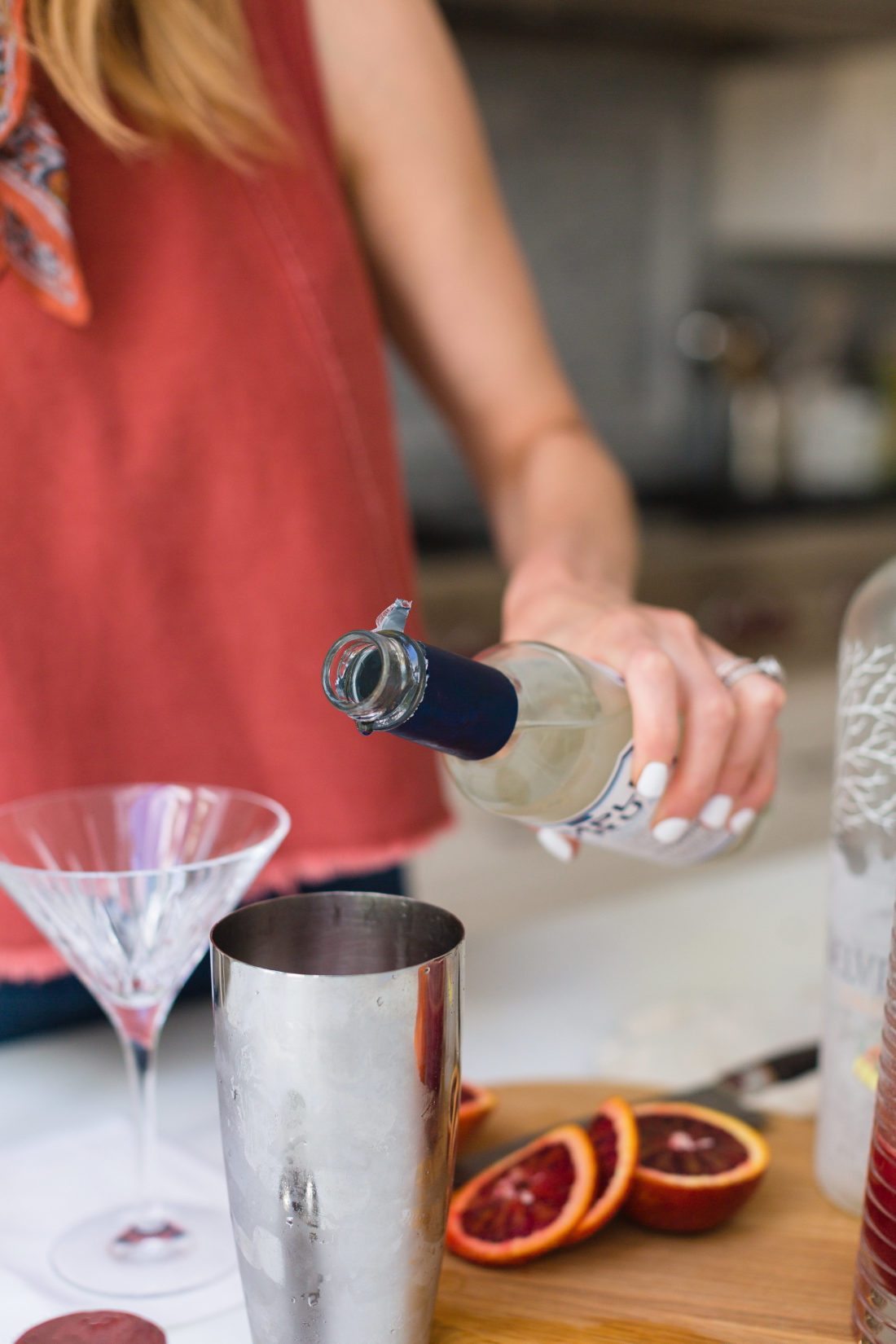 Eva Amurri Martino pours simple syrup in to her cocktail shaker in the kitchen of her connecticut home