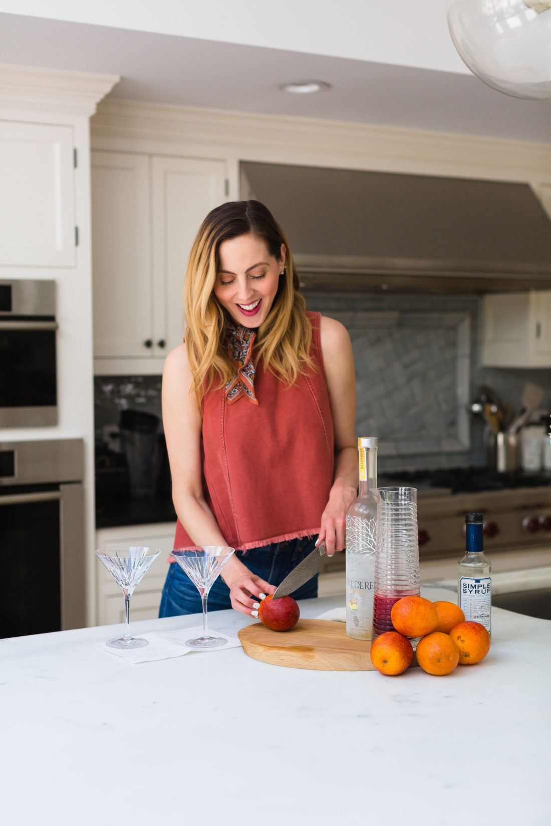 Eva Amurri Martino stands in the kitchen of her Connecticut home and slices blood oranges for martinis