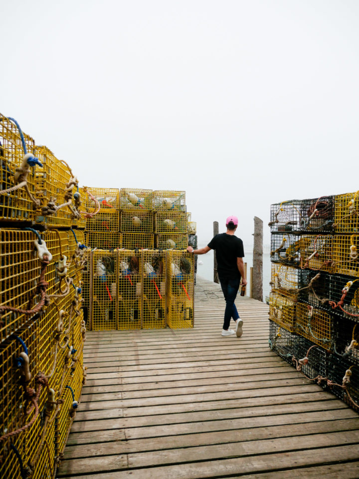 Eva Amurri Martino's husband Kyle looks out amongst the lobster crates in Bar Harbor, ME.