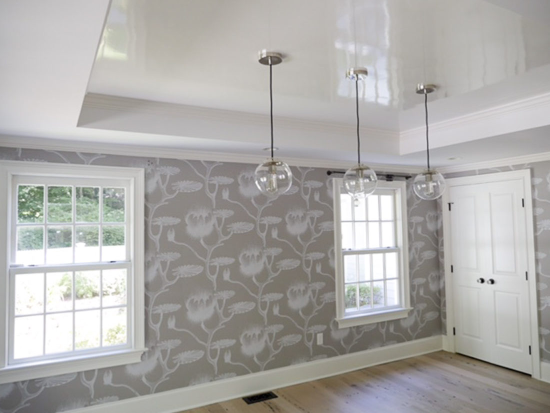 Eva Amurri Martino of the Happily Eva After blog's dining room with grey and white patterned wallpaper, industrial globe lighting and high gloss white ceiling 