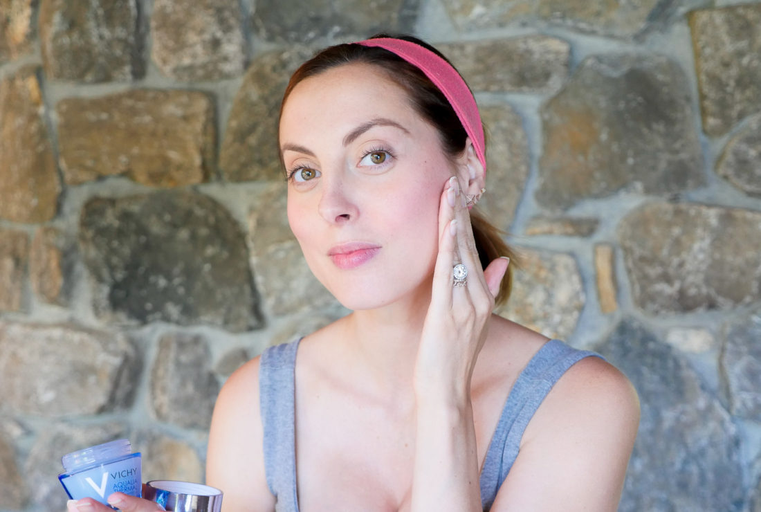 Eva Amurri Martino of lifestyle blog Happily Eva After applying a lightweight moisturizer to her bare skin
