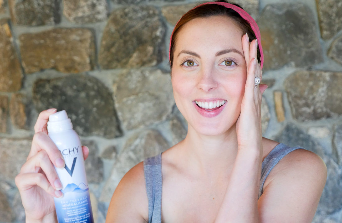 Eva Amurri Martino of lifestyle blog Happily Eva After spritzing her face with a mineralizing water to keep skin healthy