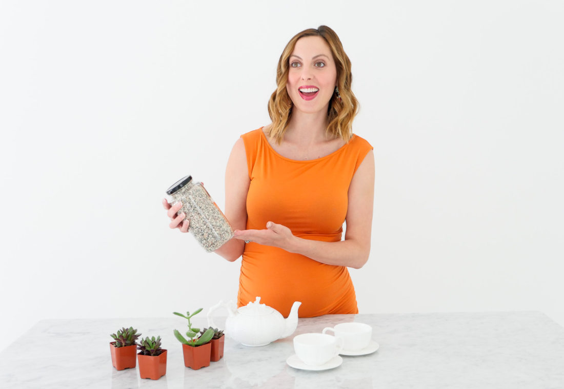 Eva Amurri Martino of lifestyle blog Happily Eva After wearing an orange maternity dress at 34 weeks pregnant shooting a craft segment in her studio in connecticut