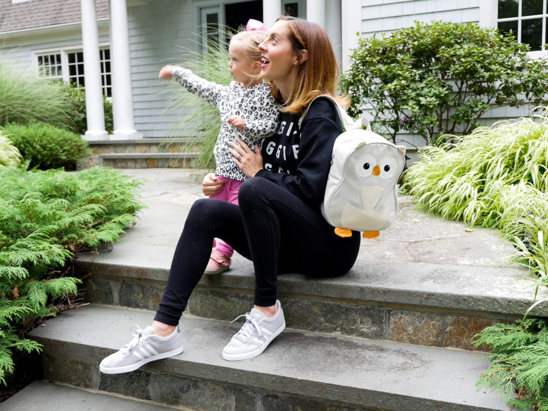 Eva Amurri Martino of lifestyle blog Happily Eva After with her daughter Marlowe sitting on their front steps together waiting to go off to school