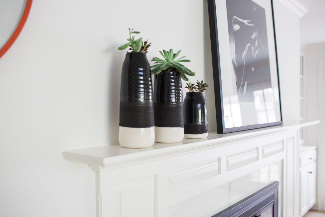 Hand thrown black and white vases on the mantle in the kitchen table area of Eva Amurri Martino's Connecticut Home
