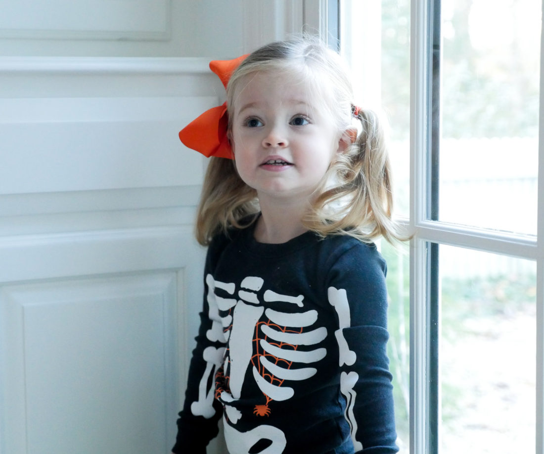 Marlowe Martino, wearing a skeleton costume and orange bow on Halloween