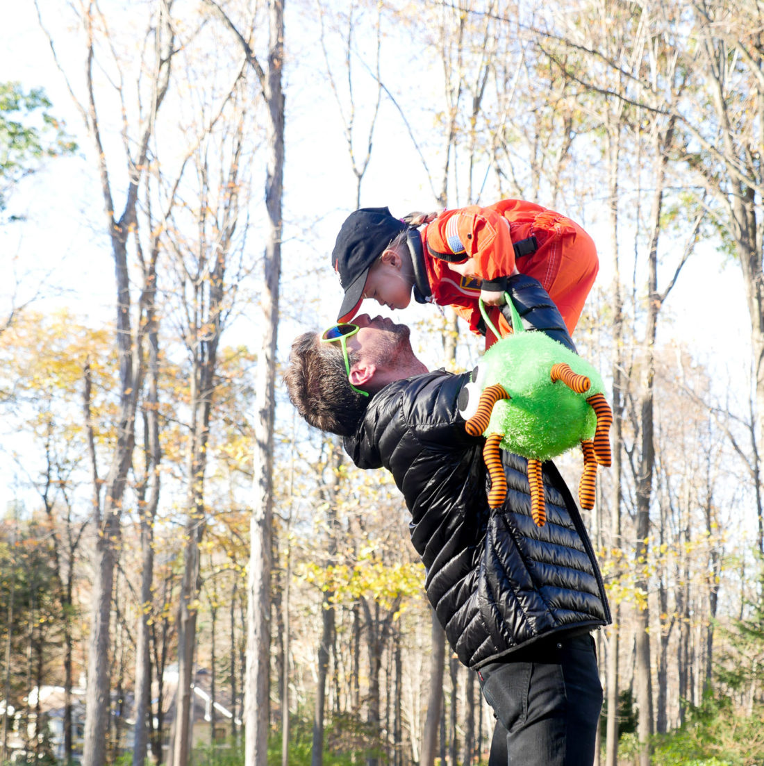 Kyle Martino holding Marlowe Martino up in the air and kissing her