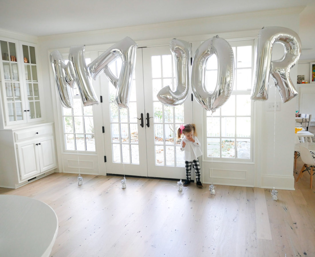 Marlowe Martino playing with balloons spelling out her little brother Major's name at his Sip And See