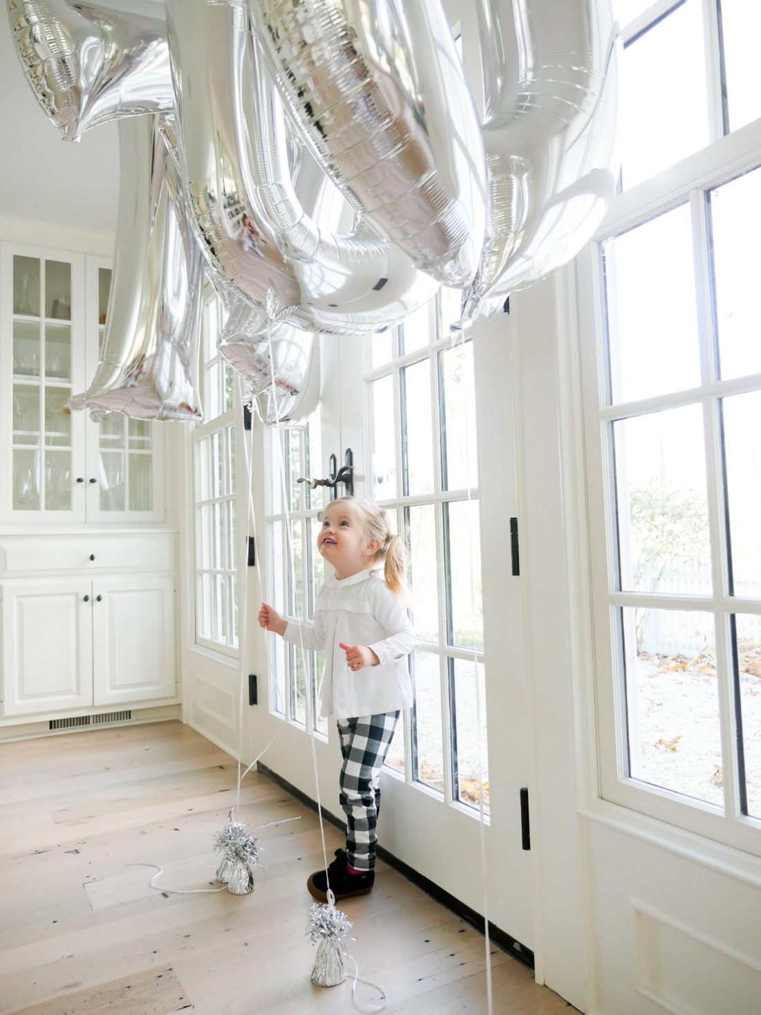 Marlowe Martino playing with balloons spelling out her little brother Major's name at his Sip And See