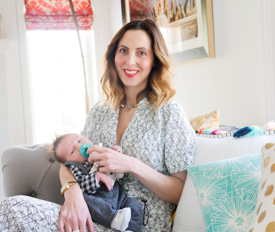 Eva amurri Martino of lifestyle and motherhood blog Happily Eva After, holding newborn son Major James at his Sip And See at home in Connecticut