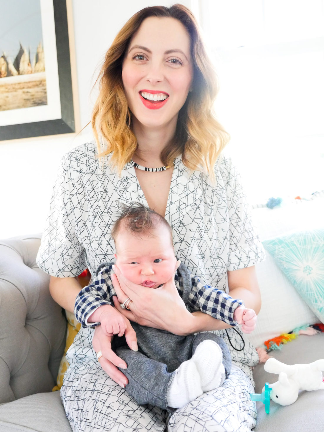 Eva amurri Martino of lifestyle and motherhood blog Happily Eva After, holding newborn son Major James at his Sip And See at home in Connecticut