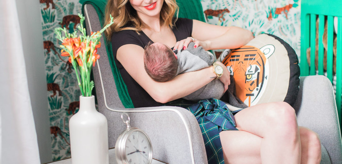 Eva Amurri Martino of lifestyle and motherhood blog Happily Eva After holds her newborn son Major in his newly designed nursery in her connecticut home