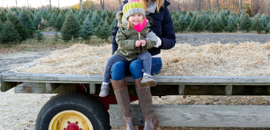 Eva Amurri Martino of lifestyle and Motherhood blog Happily Eva After takes her daughter Marlowe on a hay ride at the christmas tree farm in Connecticut