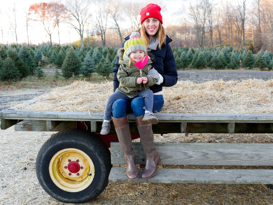 Eva Amurri Martino of lifestyle and Motherhood blog Happily Eva After takes her daughter Marlowe on a hay ride at the christmas tree farm in Connecticut