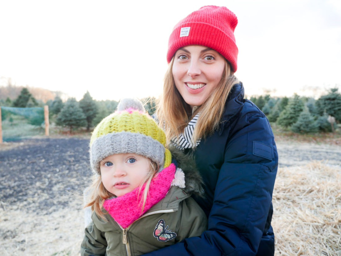 Eva Amurri Martino of lifestyle and Motherhood blog Happily Eva After takes her daughter Marlowe on a hay ride at the christmas tree farm in Connecticut