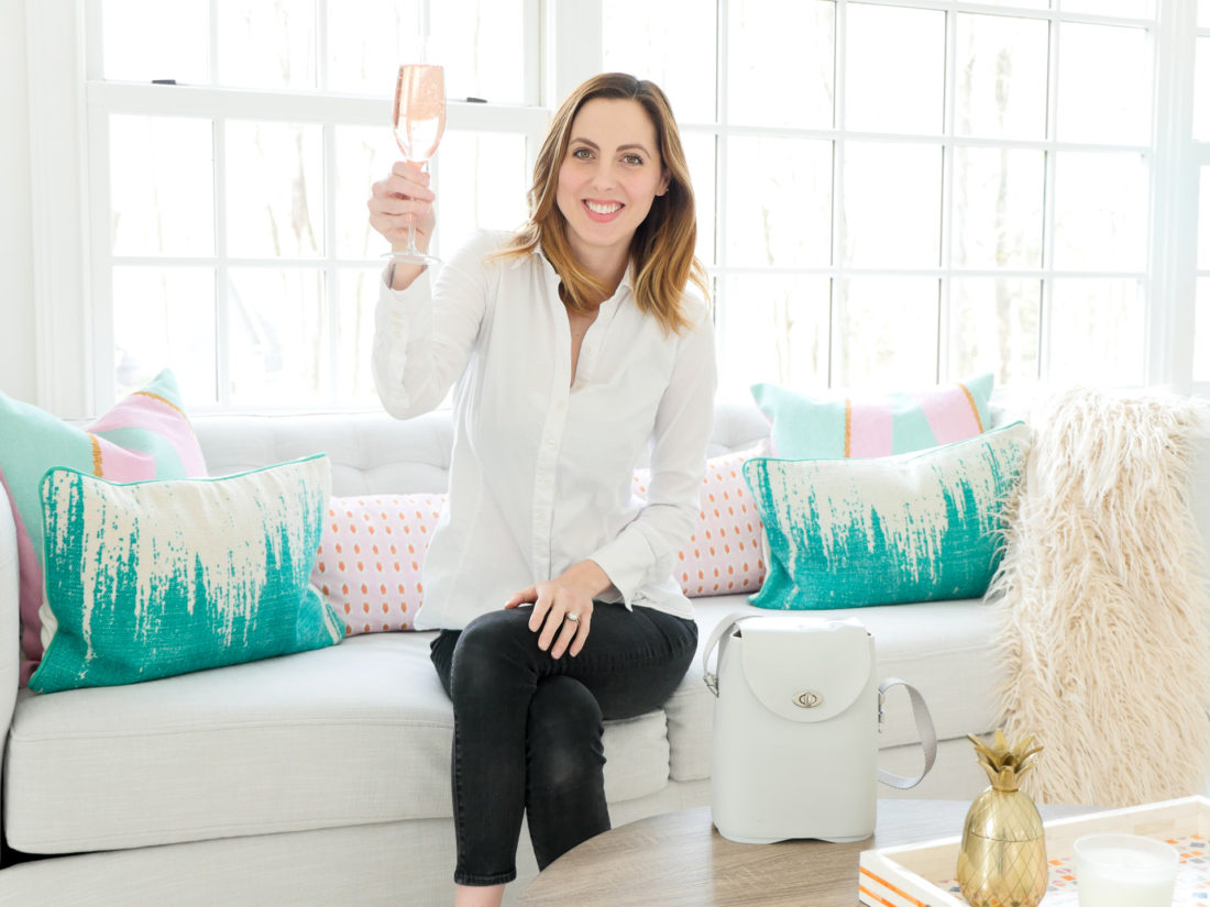 Eva Amurri Martino of lifestyle and motherhood blog Happily Eva After pictured in her studio with a glass of sparkling rose