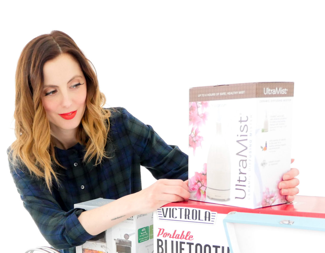 Eva Amurri Martino poses with an array of holiday gifts for friends and family