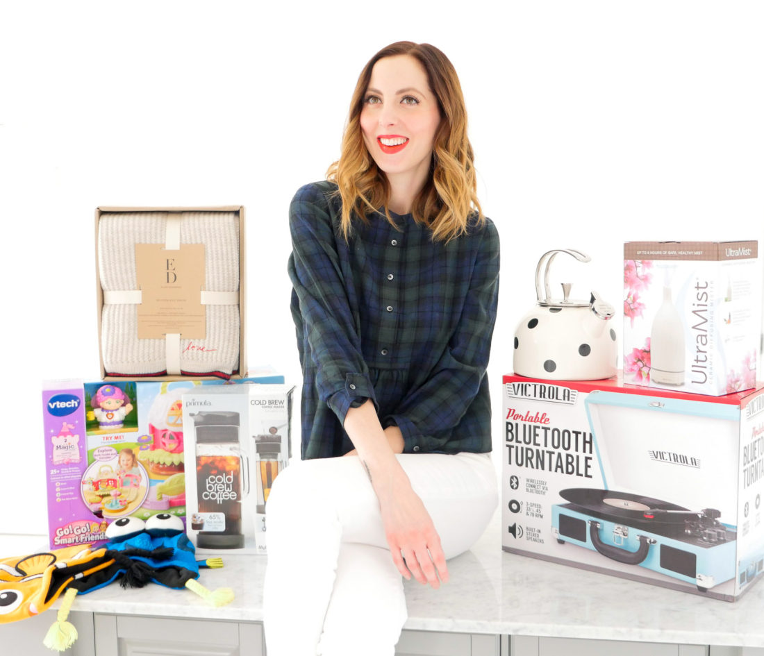 Eva Amurri Martino poses with an array of holiday gifts for her family and friends