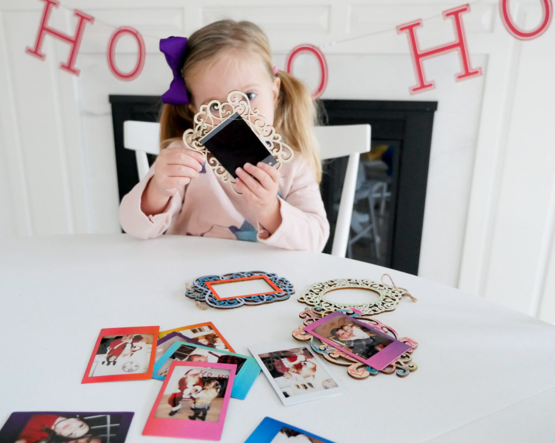 Eva Amurri Martino and two year old daughter Marloweuse plain wooden frames and craft paint to create holiday photo ornaments using the FUJIFILM Instax Mini 70 instant camera