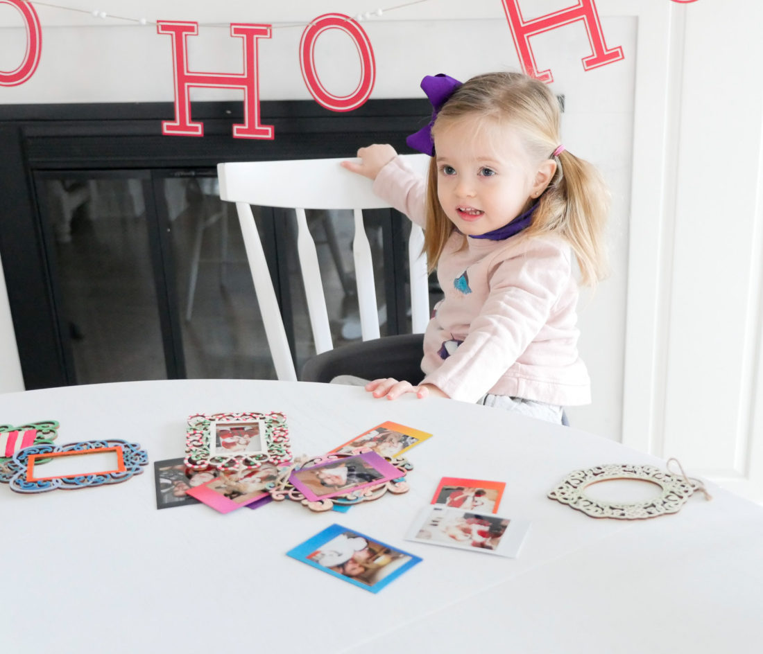 Eva Amurri Martino and two year old daughter Marloweuse plain wooden frames and craft paint to create holiday photo ornaments using the FUJIFILM Instax Mini 70 instant camera