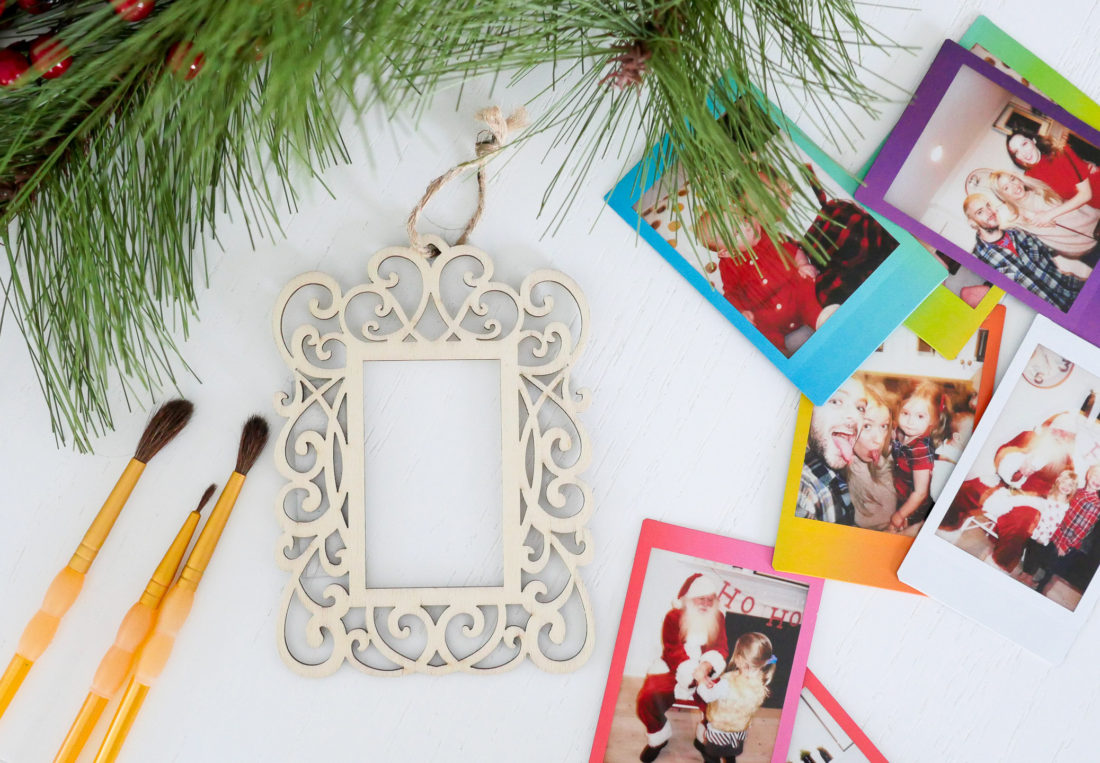 Eva Amurri Martino uses plain wooden frames and craft pain to create holiday photo ornaments using the FUJIFILM Instax Mini 70 instant camera