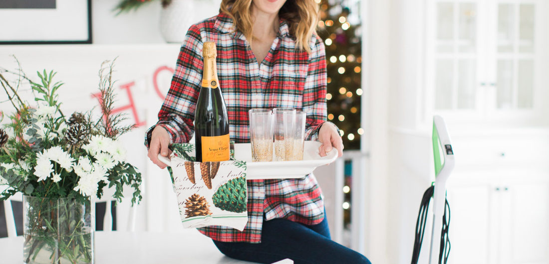 Eva Amurri Martino prepares for a holiday party in her kitchen with a tray of drinks and the bissell crosswave cleaning system