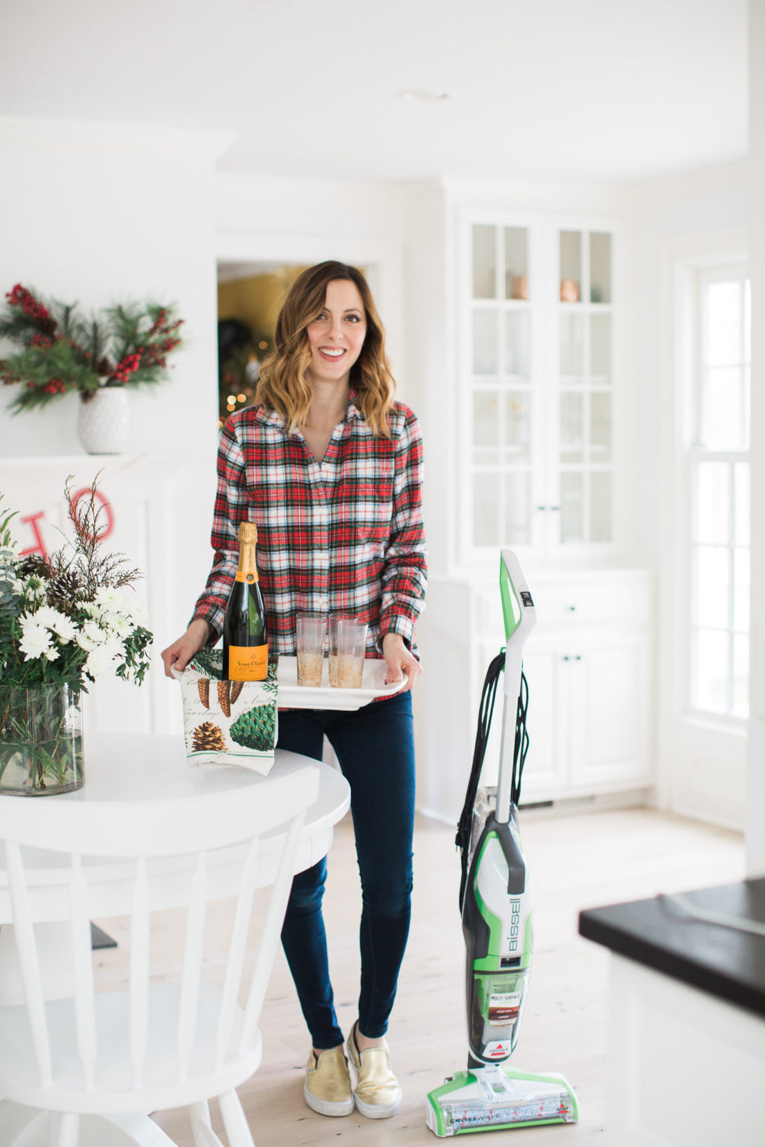 Eva Amurri Martino of lifestyle and motherhood blog Happily Eva After holds a tray of cocktails as she prepares her home for a Holiday party