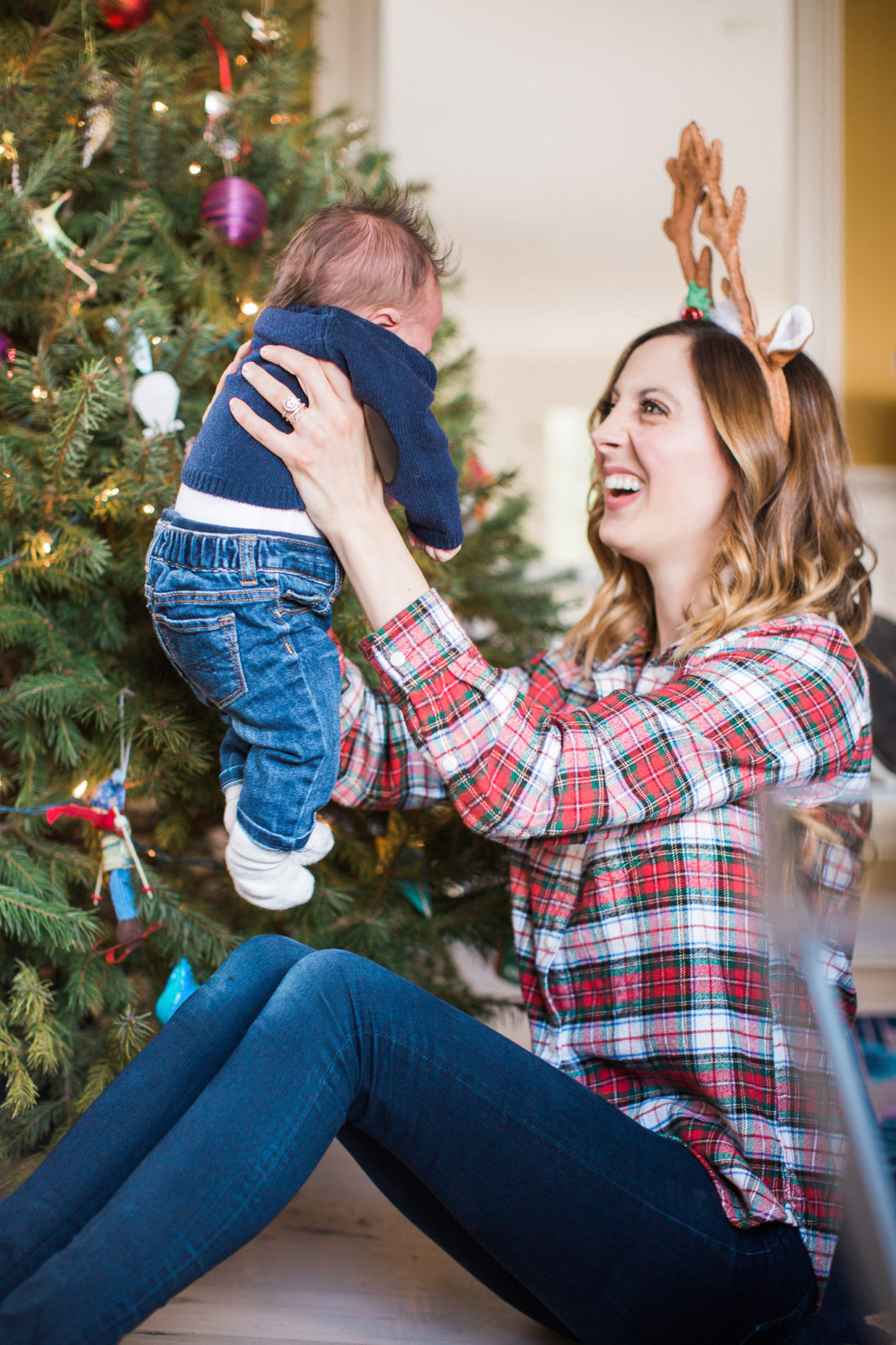 Eva Amurri Martino holds newborn son, Major, next to the Christmas Tree