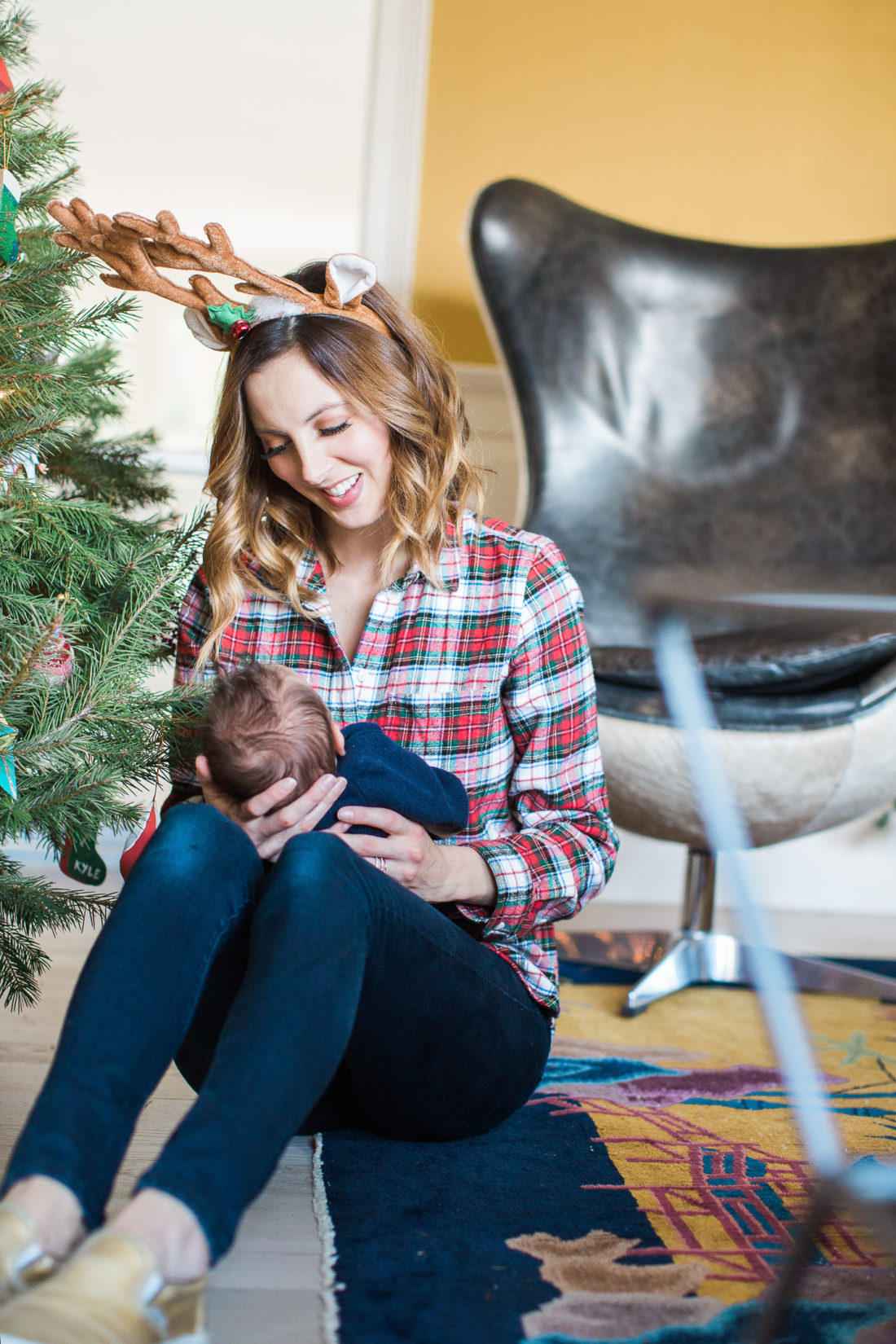 Eva Amurri Martino holds newborn son, Major, next to the Christmas Tree