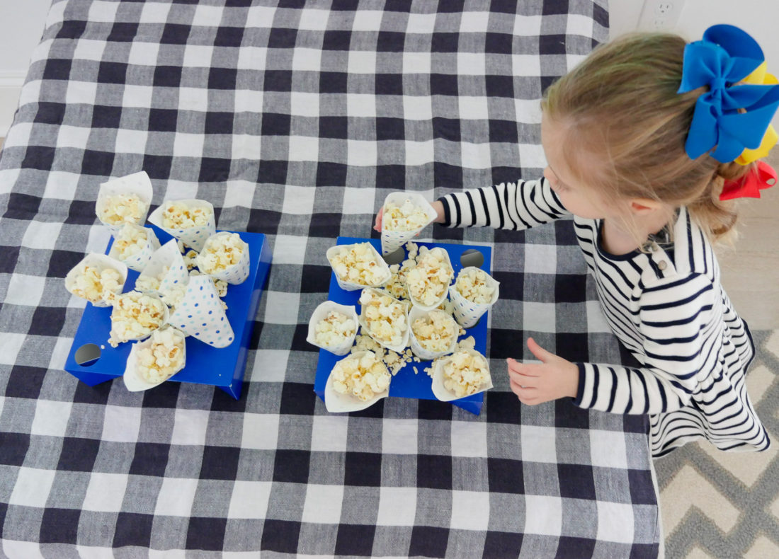 Marlowe Martino grabs a cone of popcorn