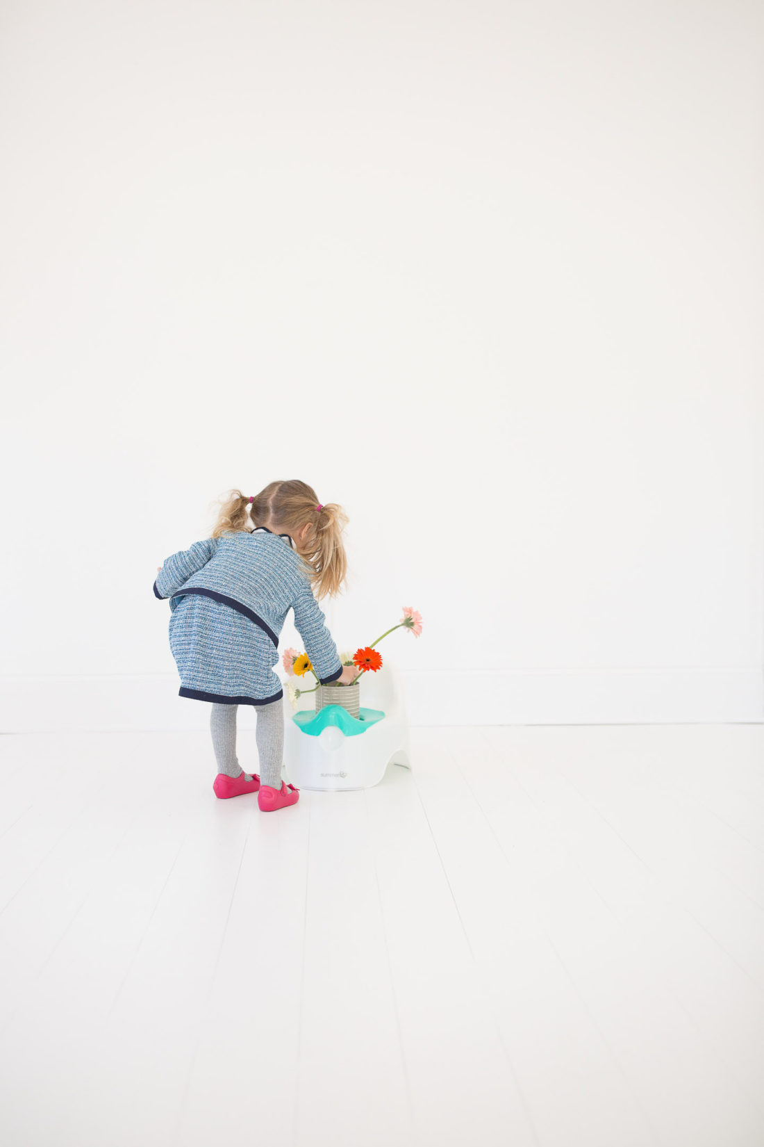 Marlowe Martino wears a tweed suit and pink kitty shoes and stands by her potty