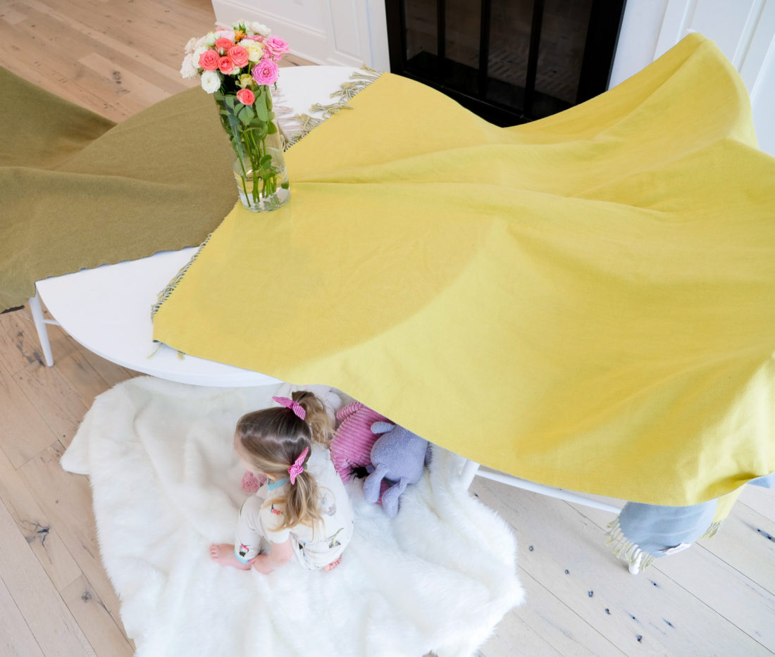 Marlowe Martino sits in her Mama-built fort underneath the kitchen table