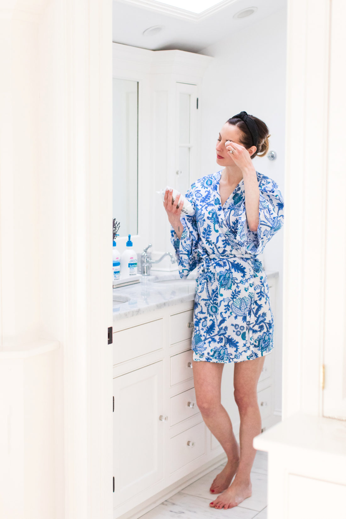 Eva Amurri Martino stands in her Master Bathroom using a Gentle Basics cleansing wipe to remove her makeup before bed