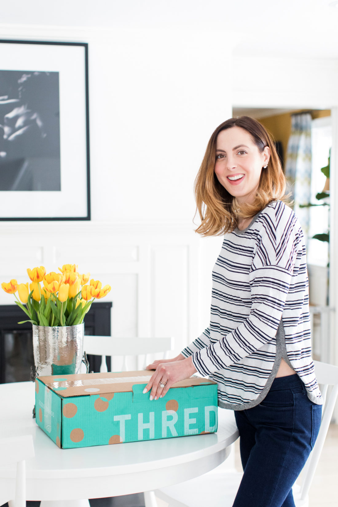 EVa Amurri Martino prepares to open her cardboard box of secondhand clothes from ThredUP
