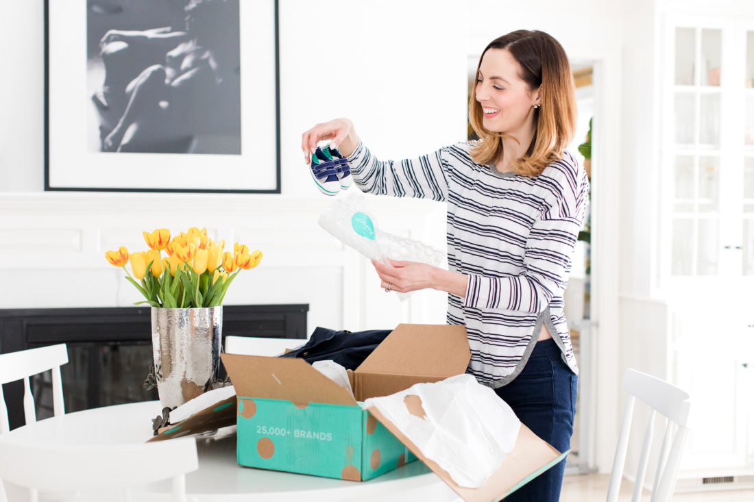 Eva Amurri Martino unpacks a tiny pair of sneakers from her thredUP delivery box