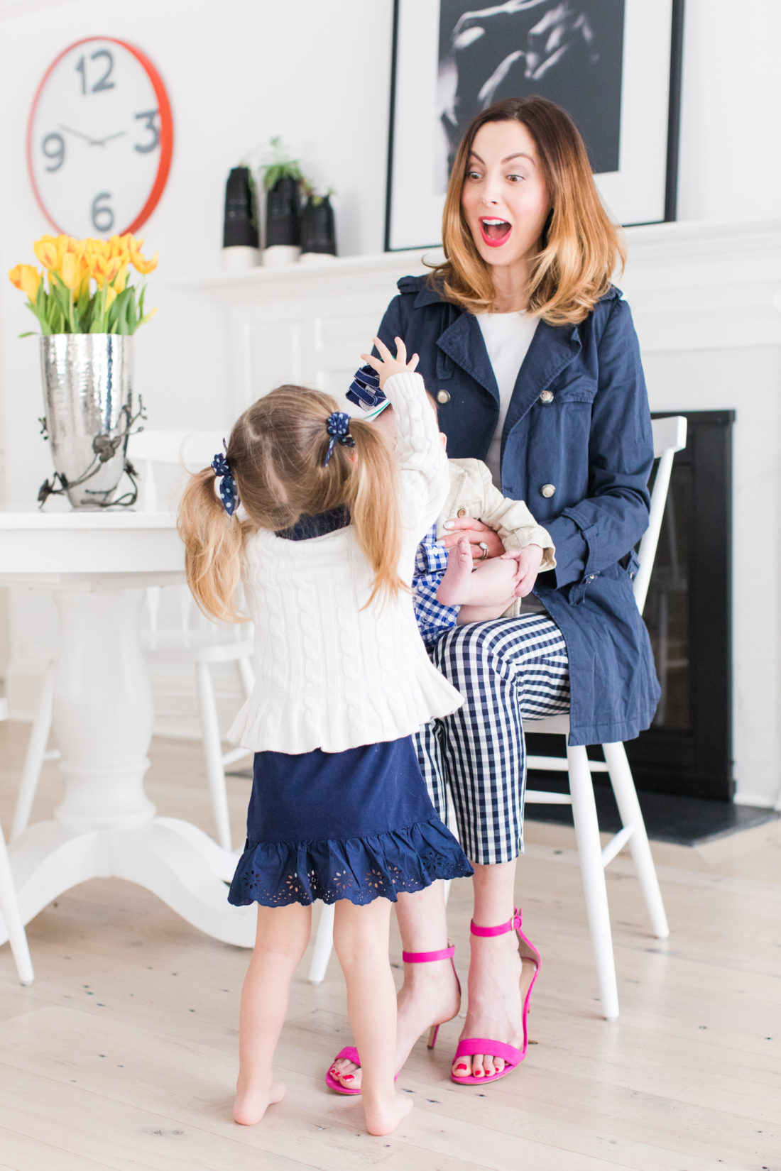 Eva Amurri Martino sits with her daughter Marlowe and son Major in the kitchen of their Connecticut home wearing coordinating navy and white outfits