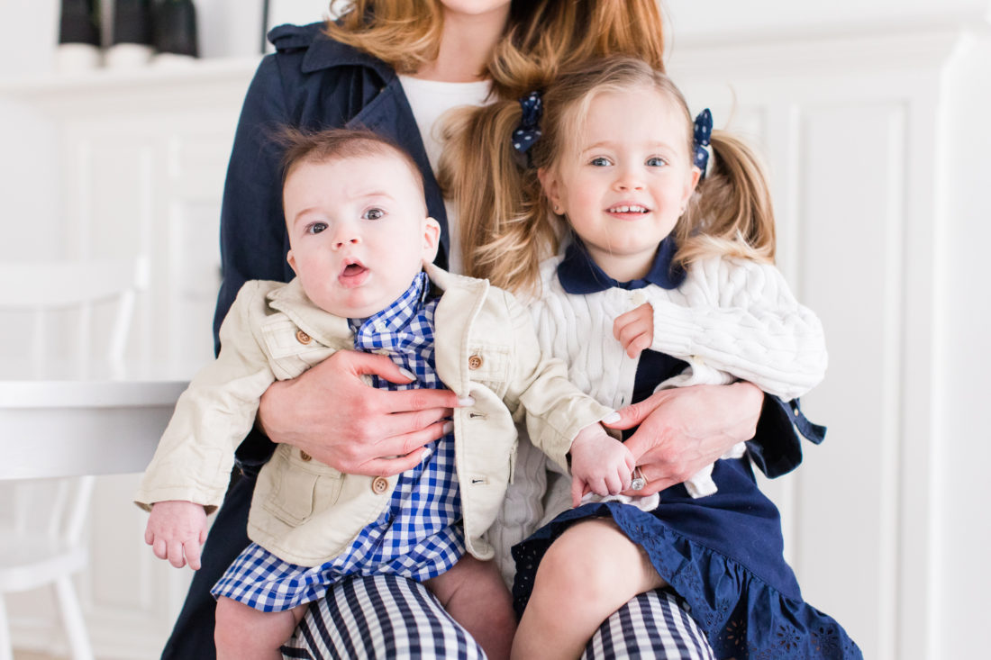 Marlowe Martino and Major Martino sit on their Mom's knee in coordinating navy blue and white secondhand outfits