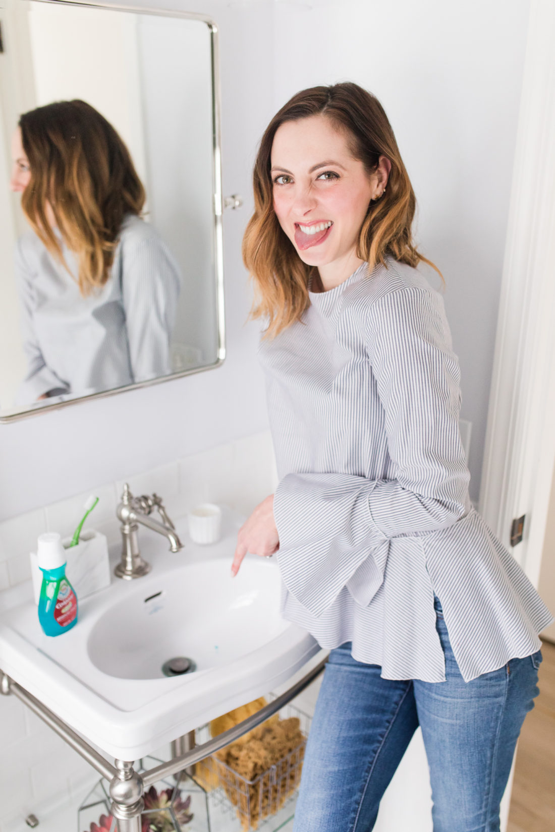 Eva Amurri Martino looks at the bacteria in the sink that have been killed by Colgate advanced health mouthwash