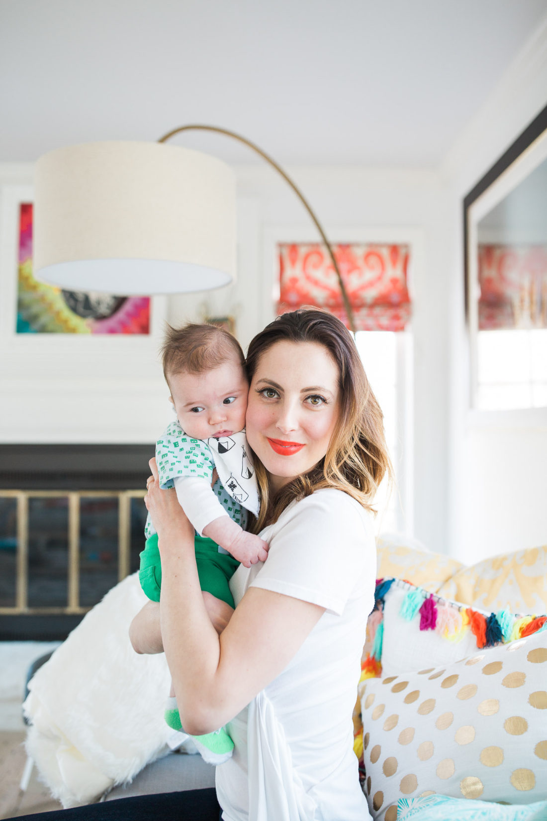 Eva Amurri Martino wears a white Tshirt and red lipstick, and holds her infant son, Major, to her cheek
