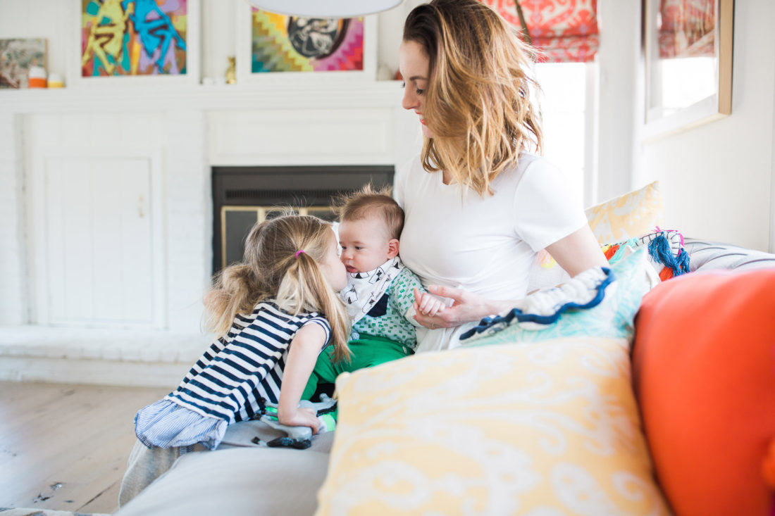 Marlowe Martino wears a striped Tshirt and kisses her little brother, Major, in the colorful Family Room of their Connecticut home