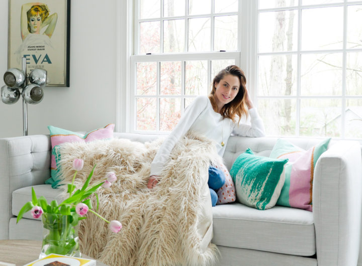 Eva Amurri Martino relaxes on the couch in the Happily Eva After studio wearing a white sweatshirt