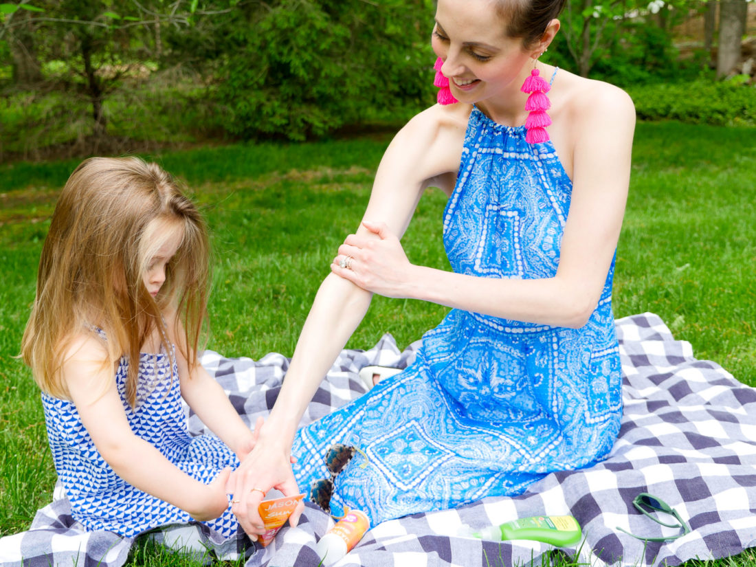 Marlowe Martino helps her Mom apply sunscreen to her arms