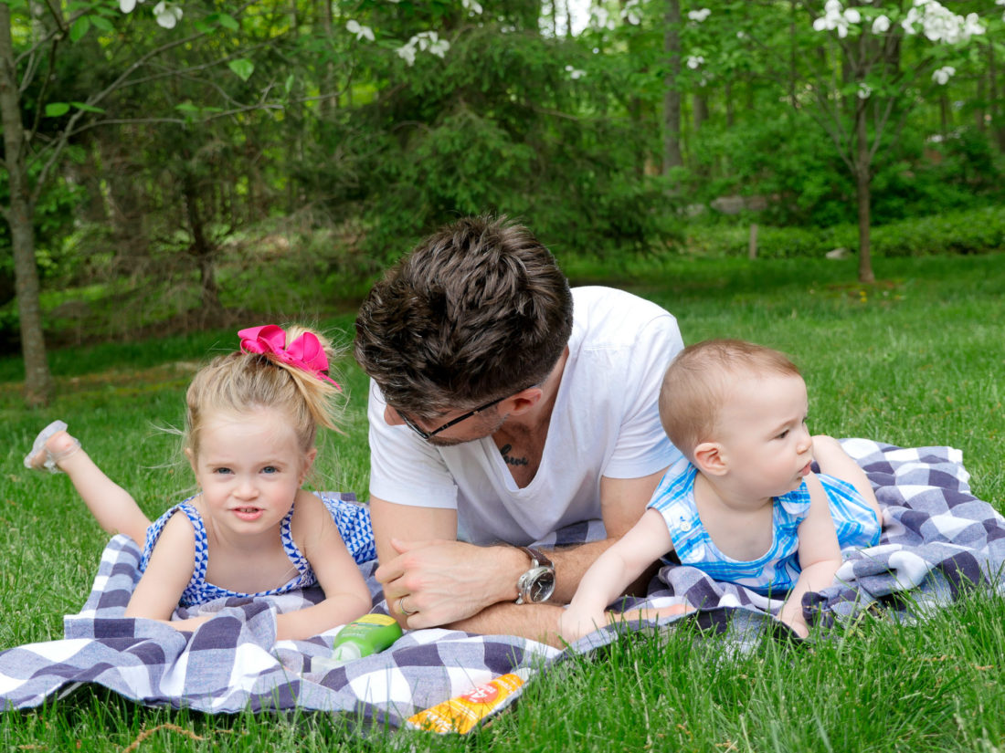 Kyle Martino relaxes on a picnic basket with Marlowe Martino and Major Martino near their home in connecticut